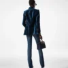 Pantalones acampanados de denim elástico sin tratar
